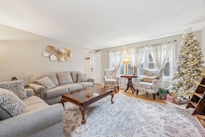 Living room offering comfy furniture, games and a cozy fireplace