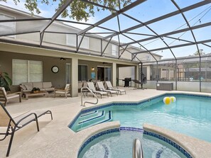 Our large patio includes a sitting area, dining area, lounges, hot tub, and pool