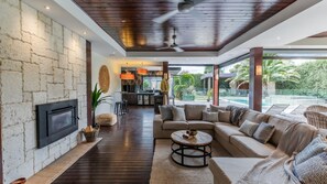 Outdoor living and dining with outdoor blinds. views of the pool, outdoor fireplace