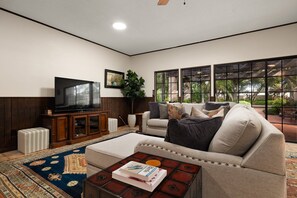 Family room equipped with a large sectional, game table, bar and beautiful view!