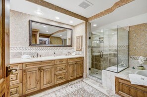 Indulge in our spa-like bathroom, featuring dual sinks, a walk-in shower, and luxurious finishes. A perfect place to unwind and refresh.