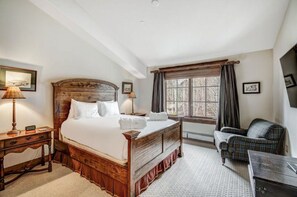 Sleep soundly in our elegant master bedroom, offering a king-sized bed, cozy seating area, and large windows with stunning views. A peaceful retreat for ultimate relaxation.