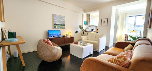 Comfortably furnished living room with Smart TV and ceiling fan