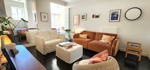 Comfortably furnished living room with Smart TV and ceiling fan