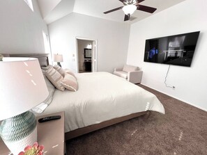 This spacious master bedroom offers a cozy king-sized bed, a private ensuite full bathroom, and modern touches like a large mounted TV for relaxation. Designed for comfort and convenience, it’s the perfect retreat after a long day.