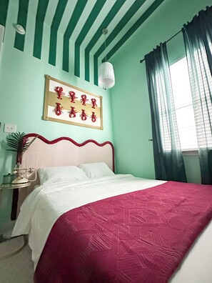 Plush bed with New Orleans themed decor