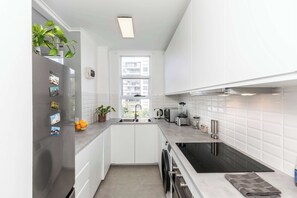 large family size fridge freezer and induction cooktop in kitchen
