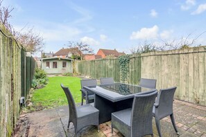 Garden room with a view of the outdoor seating area and spacious yard.