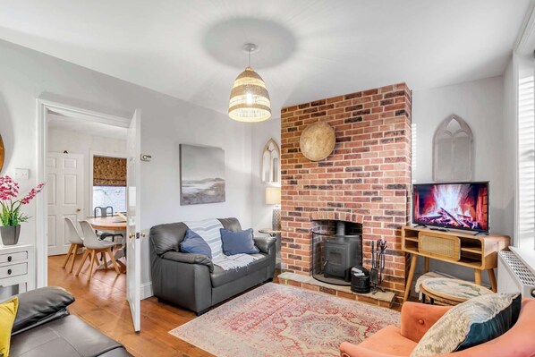 Cozy living room with a brick fireplace and inviting decor.