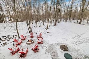 Gather around the outdoor firepit, surrounded by cozy Adirondack chairs, and enjoy the serene winter landscape – perfect for roasting marshmallows or sharing stories under the stars!