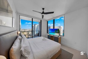 A serene bedroom with natural light and a view to wake up to.