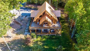 Unwind on the spacious deck or charming porch, perfect for soaking up the peaceful forest atmosphere.