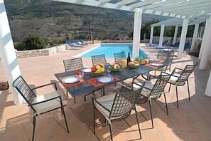 A luxury semi-detached villa with a large shared pool,