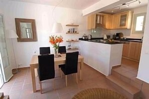 and a very well equipped kitchen with adjacent dining area.