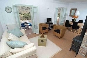 a tastefully decorated open plan living area with sofa bed,