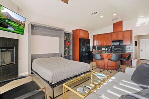 Living area with comfy seating, Smart TV, and murphy bed