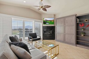 Living area with comfy seating, Smart TV, and murphy bed