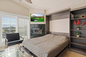 Living area with comfy seating, Smart TV, and murphy bed