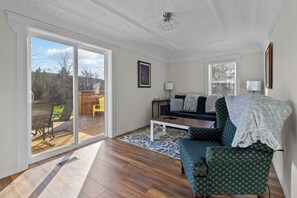 Relax in the spacious living room featuring a big glass door for plenty of natural light
