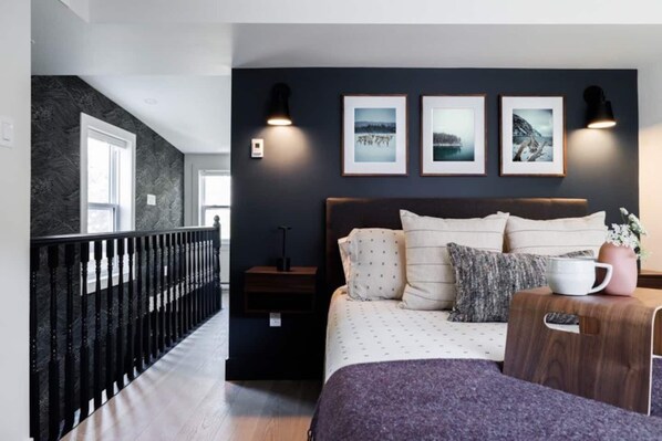 Relax in style! This bedroom invites you to unwind with soft linens, warm lighting, and a touch of elegance #QueenComfort #QVTides