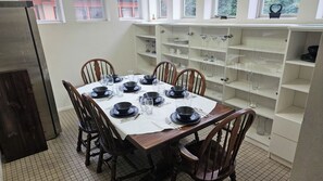 Dinning  room with 2 Full size fridges, table is even set.