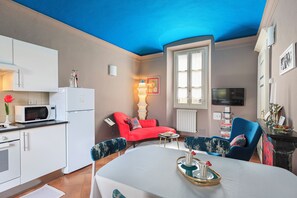 Well-equipped kitchenette. Dining table in vintage style with velvety colors