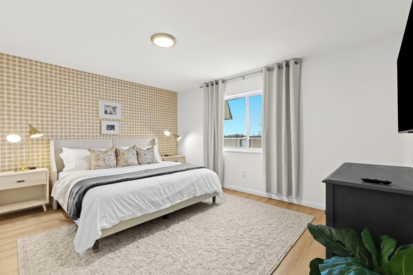 Relax in the comfort of this spacious king bedroom, designed for restful nights and peaceful mornings.