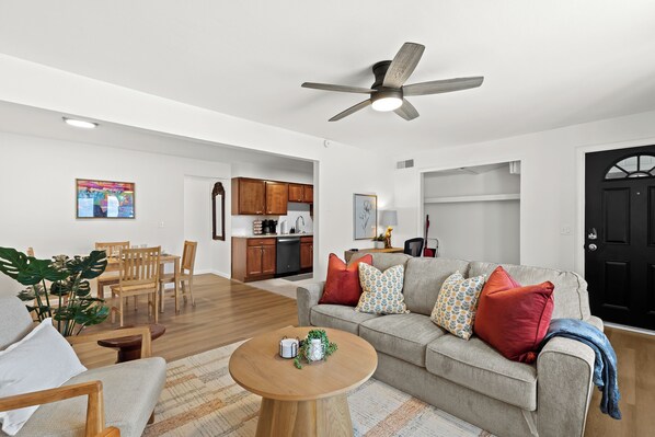 Bright, open-concept living room with cozy seating, stylish accents, and a welcoming layout—perfect for relaxing or gathering with friends and family.