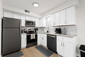 Whip up your favorite dishes in this sleek, fully-stocked kitchen designed for convenience and style.