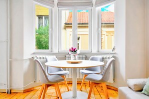 Dine in style in this bright and airy dining area, surrounded by natural light and a view of the charming outdoors.