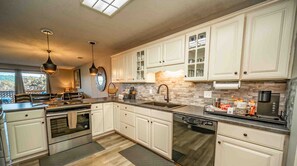 Modern Branson vacation rental kitchen with stainless appliances and white cabinets