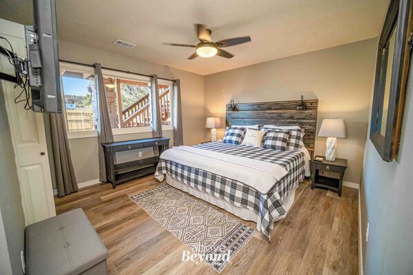nviting Branson bedroom with queen bed, checkered bedding, and natural light