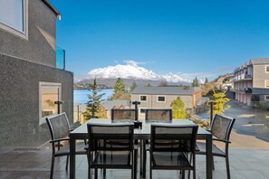 Large outdoor balcony with lovely lake and mountain views
