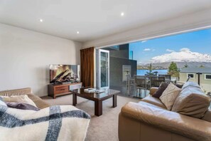 Wonderfully cozy open plan living room with lake and mountain views.