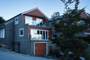 Contemporary two-level home with dual balconies and lake outlook.