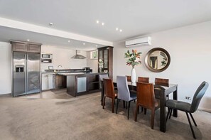 Large open plan kitchen, dining and living areas featuring a heat pump (air con).