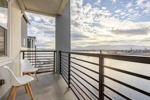 Step onto your private balcony and take in the stunning marina and mountain views—an ideal spot to relax and enjoy the peaceful waterfront ambiance.