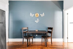 A quaint dining nook located in the kitchen, perfect for enjoying meals with seating for two.