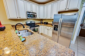 - Well equipped kitchen featuring stainless steel appliances and plenty of counter space - Classic cabinetry and modern finishes make meal preparation a breeze - Welcoming space to cook, gather, and enjoy delicious homemade meals
