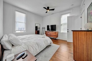 Bedroom 1: Spacious bedroom featuring a luxurious king-sized bed and a smart TV, perfect for relaxation and entertainment.