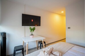 Relax and unwind in the comfortable sitting area of this stylish studio apartment.