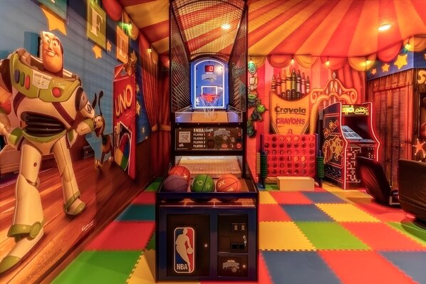 Ultimate themed game room with arcade, basketball, and vibrant Toy Story decor.
