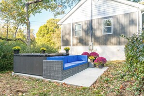 Relax in the backyard hot tub, complete with a comfy sofa for ultimate comfort.