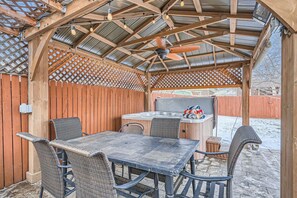 Step outside to the covered patio, complete with seating for six and a private hot tub - perfect for outdoor dining or relaxation.