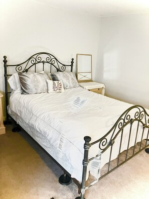 First floor bathroom with the queen bed and a walk-in closet also has a TV.
