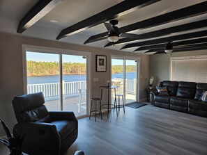 Open living room leads to large waterfront deck 