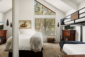 Master bedroom featuring a king size bed and a twin over twin bunk bed set.