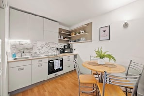 Clutter-free surfaces and neatly arranged essentials keep the kitchen space functional yet refined.