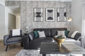 Unwind in the spacious living area complete with a comfy couch to relax after a long day exploring the city!