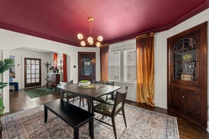 A dining room dream, complete with a stunning burgundy ceiling and rich gold drapes. ✨  Perfect for a cozy dinner party. #homedecor